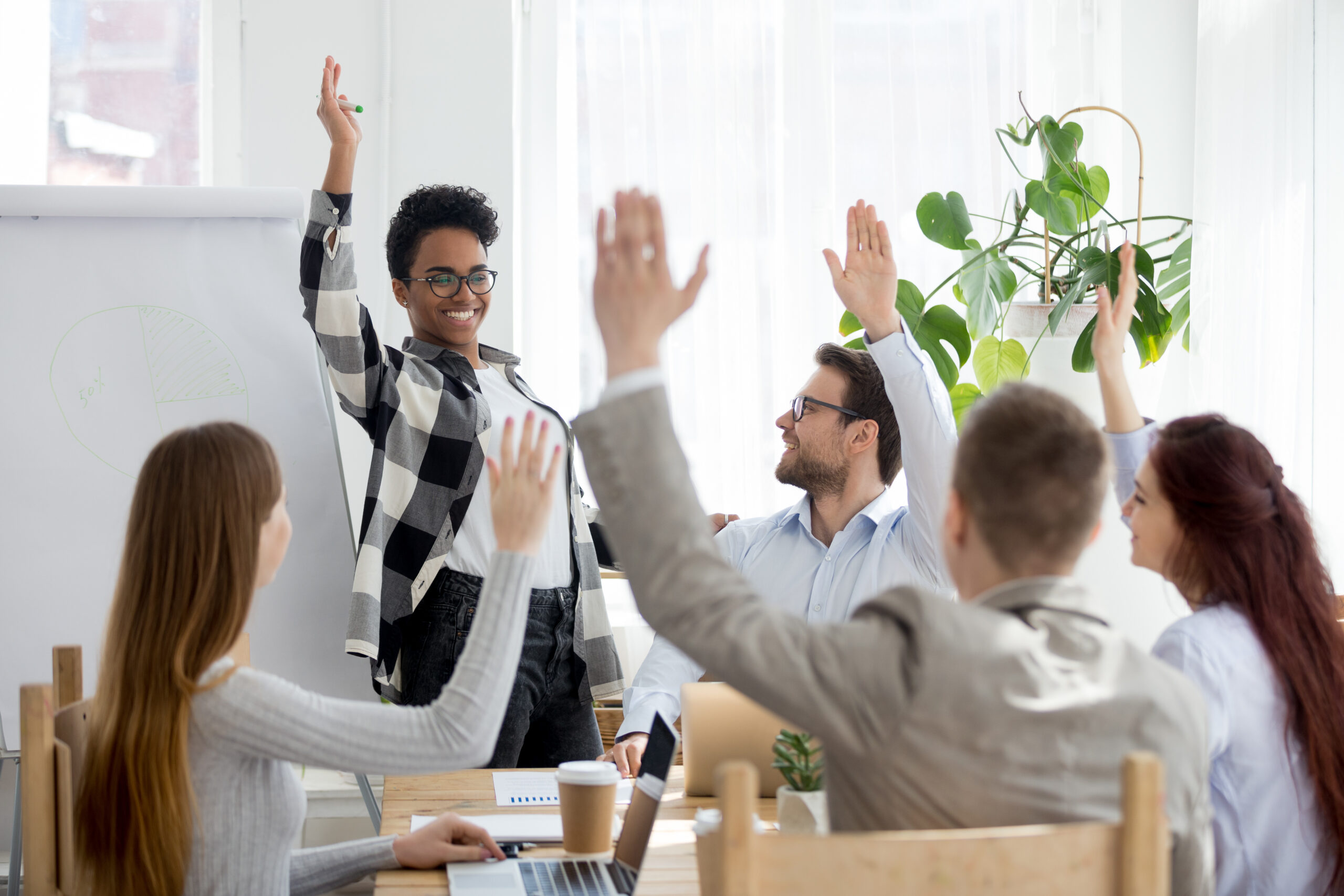 Diverse business people group raise hands at corporate presentation training 