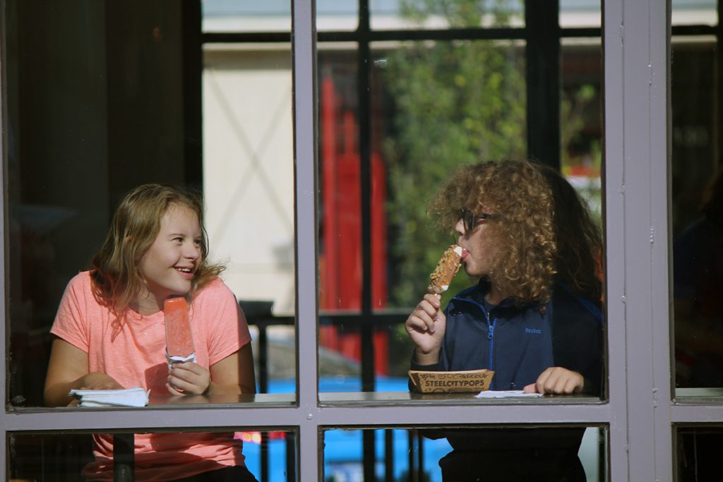 Photo of girl with Down syndrome and friend eating ice-cream.