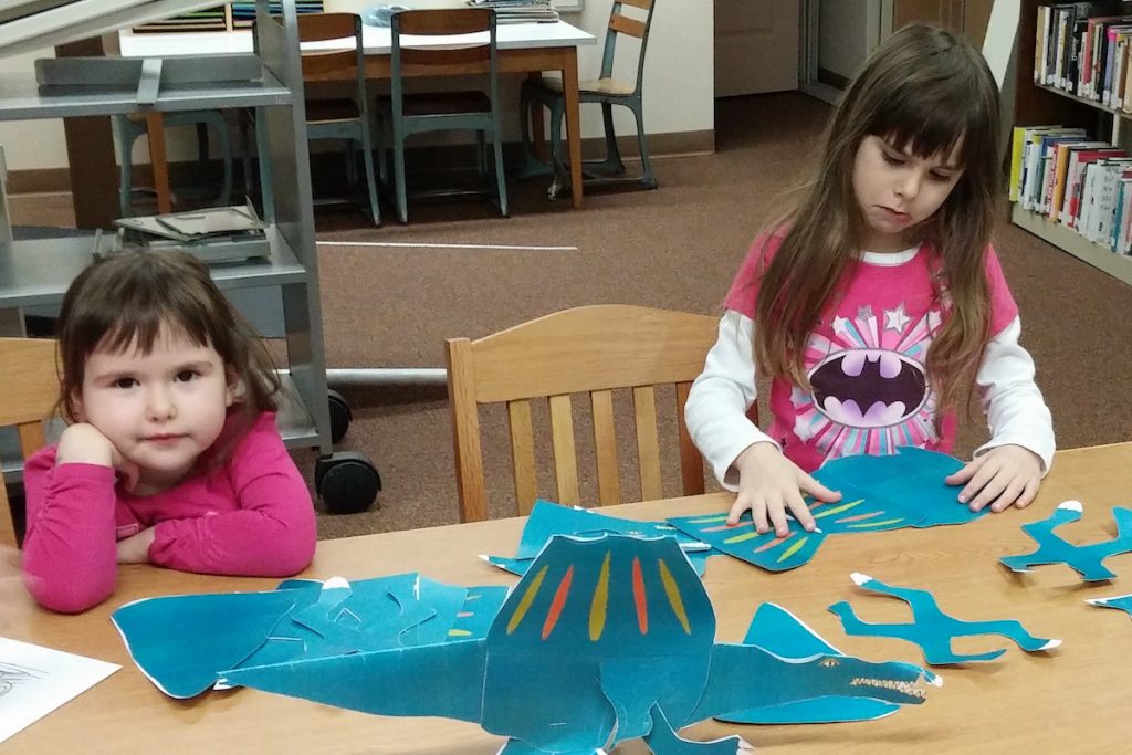 Photo of two children playing together at the library.