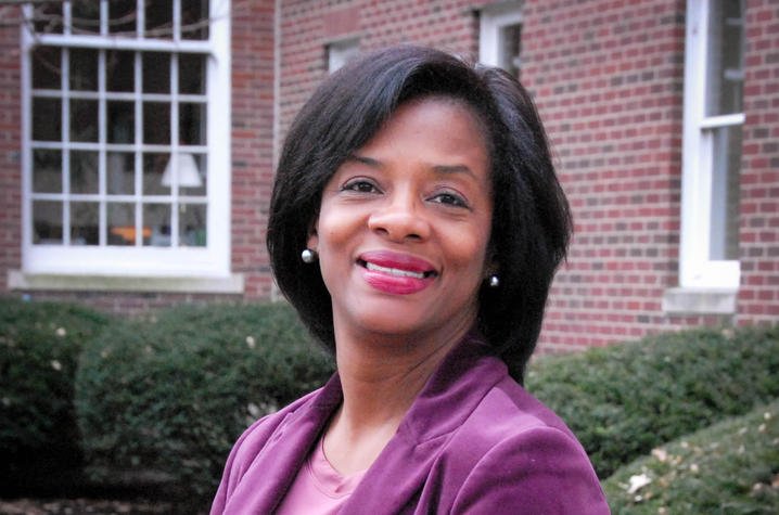 Middle-aged professional African American woman wearing a purple jacket