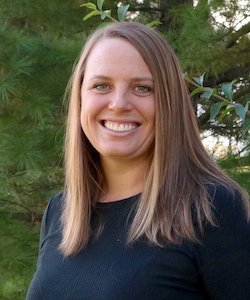 Julie Pfeiffer staff photo. She has long, brown hair and is wearing a black shirt.