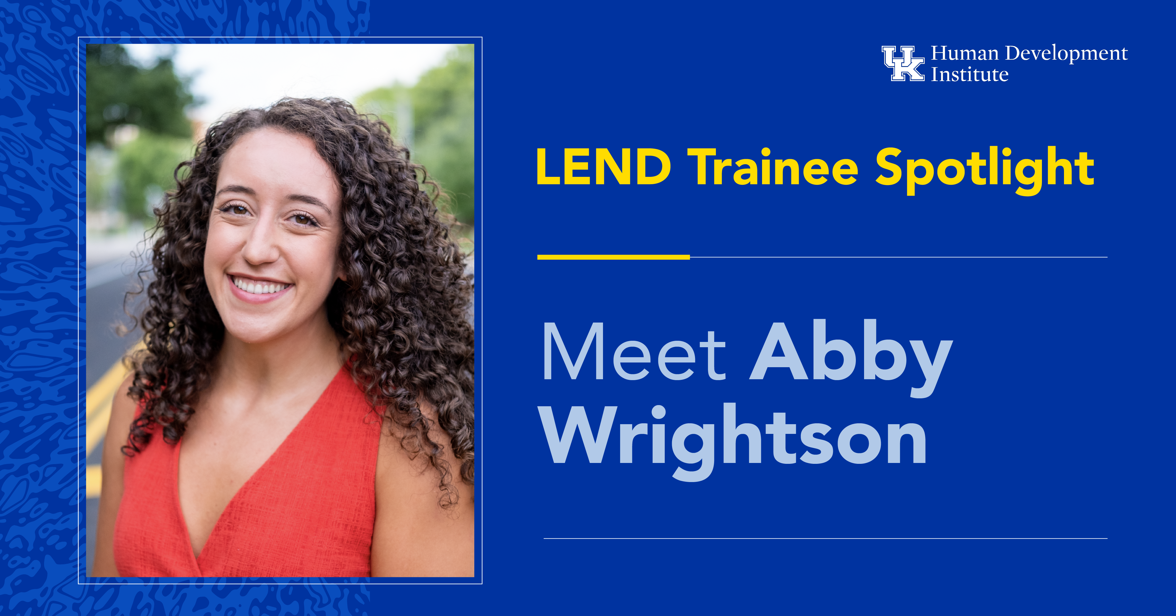 KYLEND Trainee: Meet Abby Wrightson. Abby has long, curly brown hair and is wearing an orange blouse, smiling for the camera.