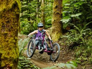 Person using an adaptive bike in the woods