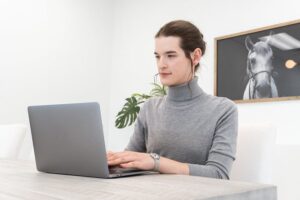 Someone working at a laptop in an office