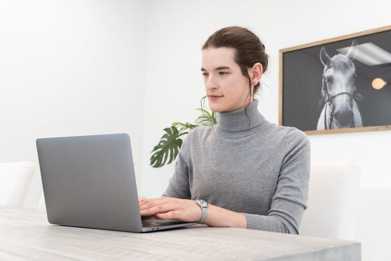 Someone working at a laptop in an office