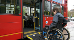 Person using a wheelchair ramp to enter a bus